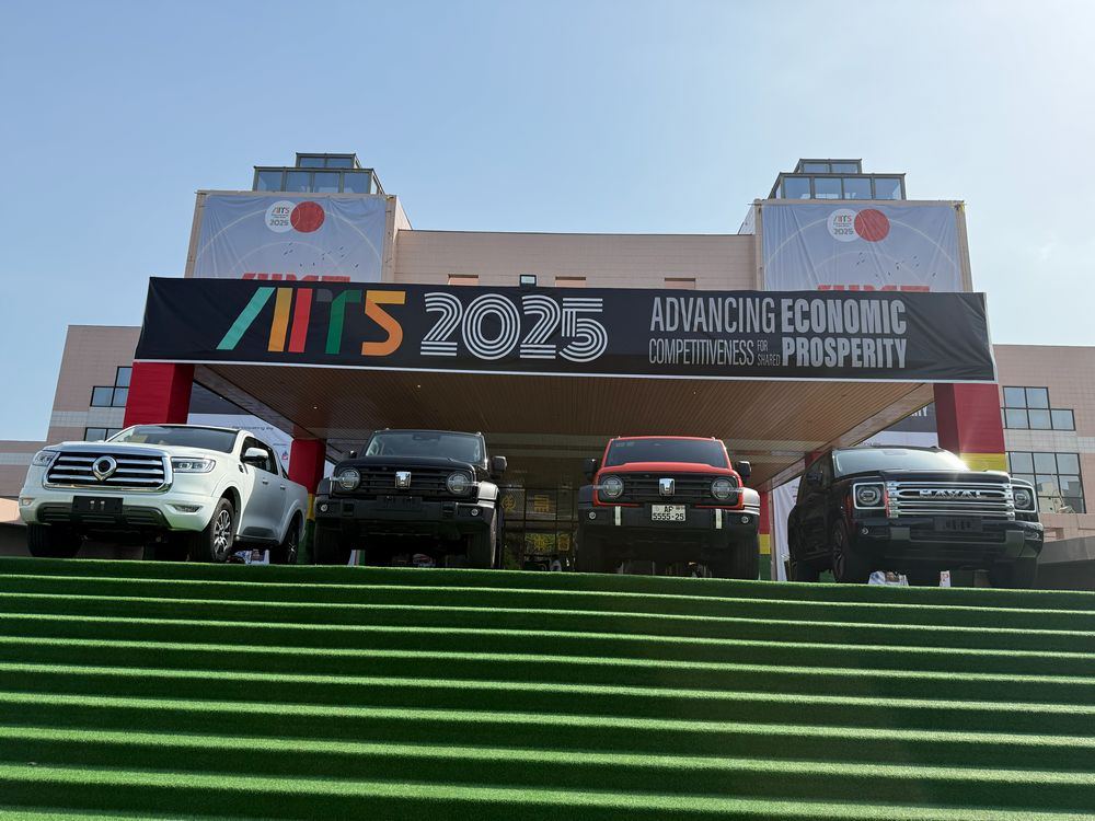 Vehicles on display at the entrance to AITS 2025