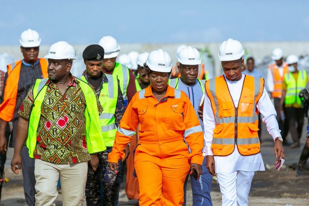 Delegates tour an active construction site in hard hats and hi-vis
