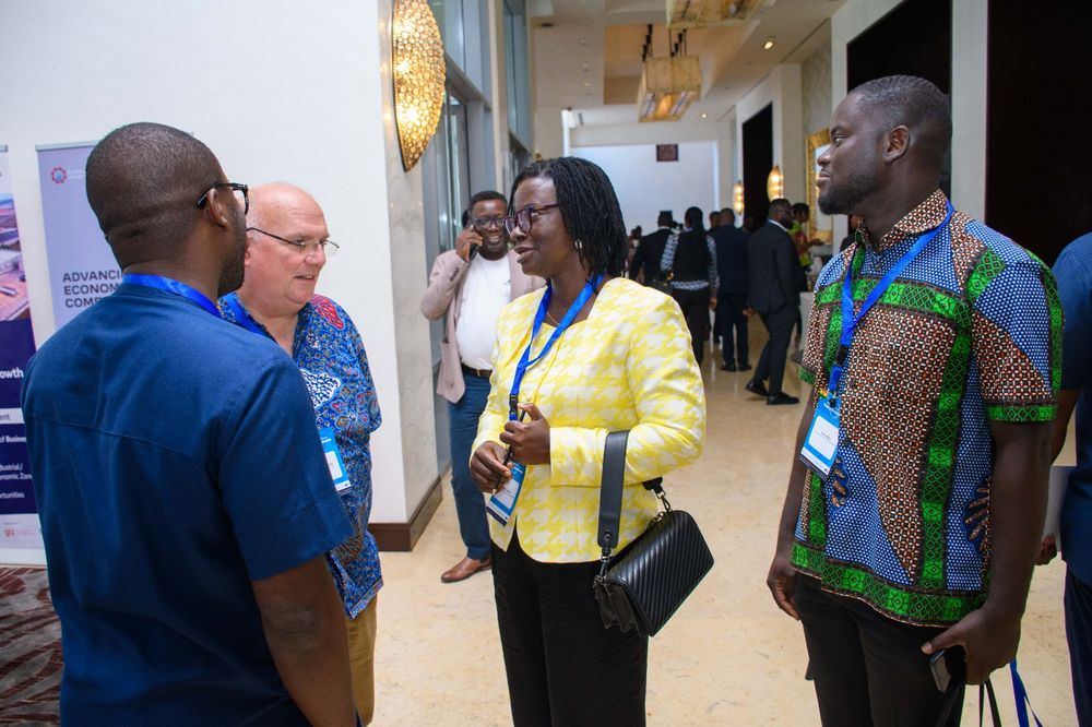 Delegates network in the hallway between conference sessions