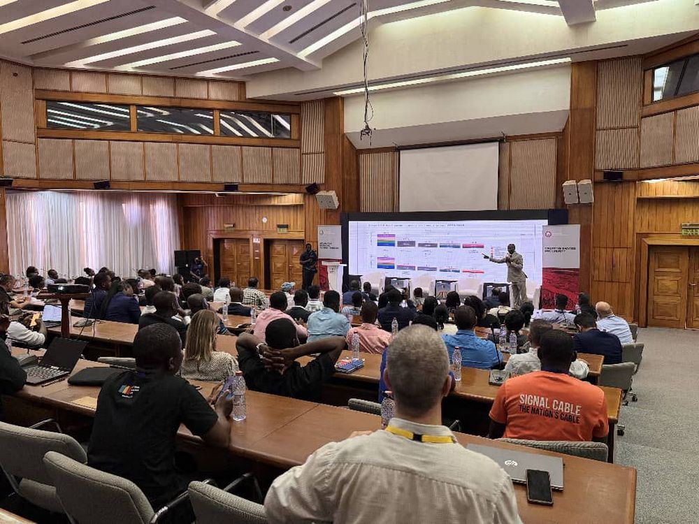 A speaker presents to delegates in a lecture-hall session
