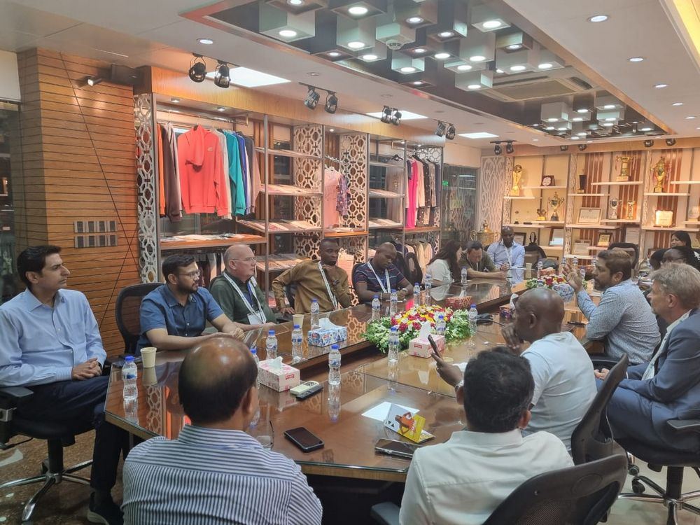 Delegates meet with a manufacturing partner during a facility visit
