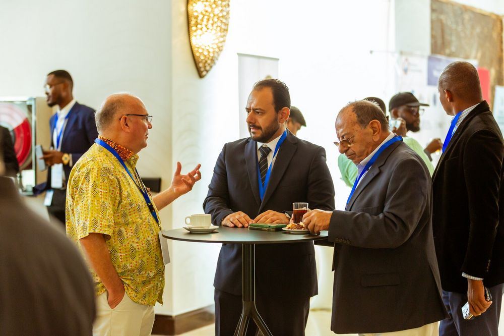 Attendees network over coffee during a conference break
